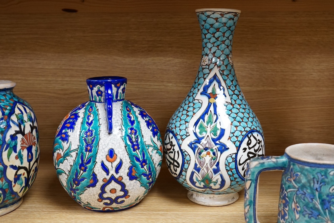 Two Persian vases and a mug, decorated with stylised flowers together with a Laroche Belgium Persian style vase, tallest 28.5cm. Condition - fair to good